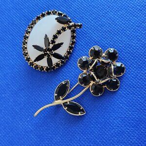 1960-s TWO VINTAGE BLACK CRYSTALS AND MILK GLASS FLOWER BROOCH